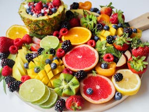 A vibrant assortment of fresh fruits beautifully arranged on a platter, perfect for a healthy and delicious snack.